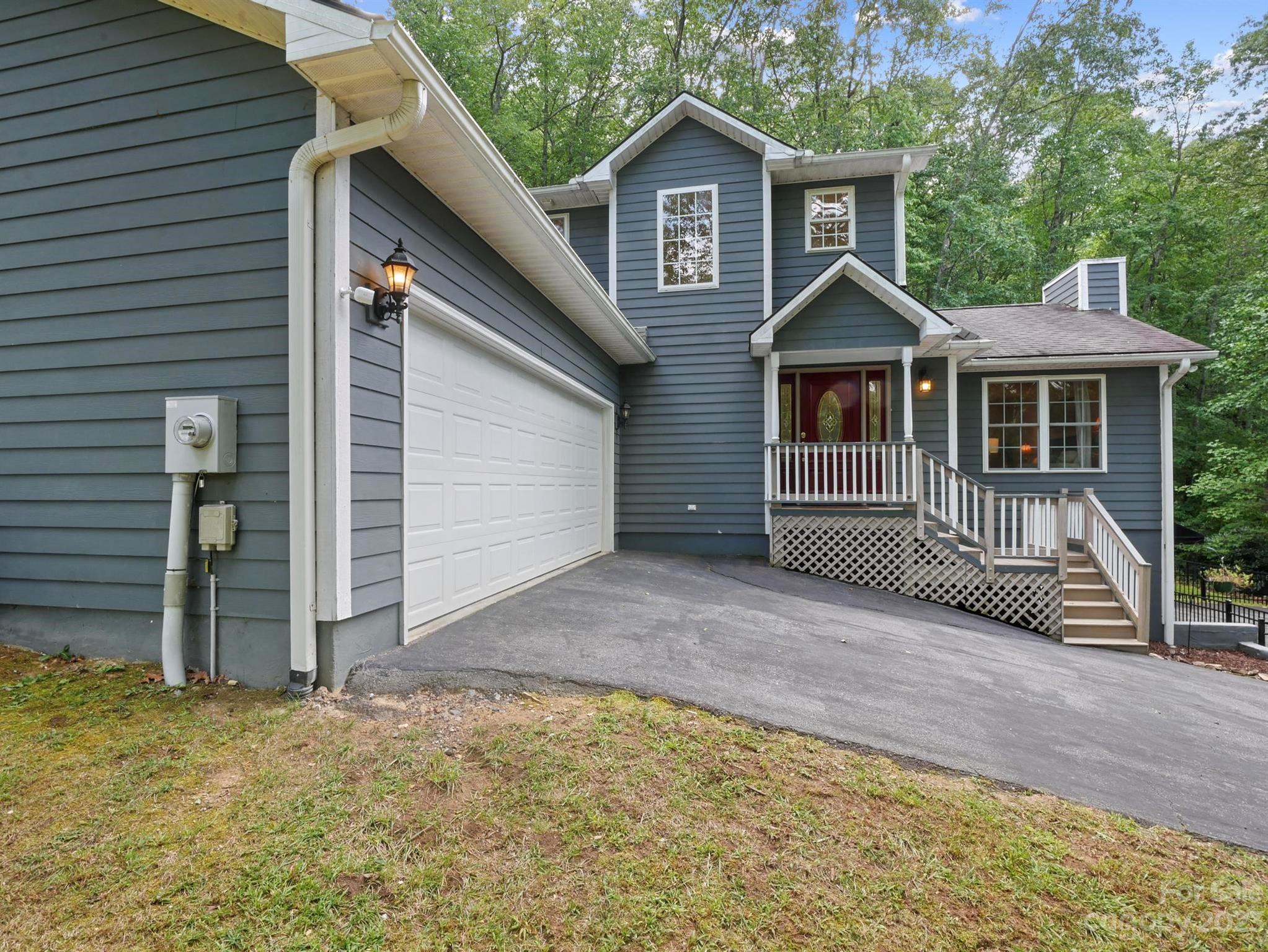 25 Falcon Crest Drive Fairview, NC 28730 - Photo 35 of 41 a front view of a house with a yard and garage