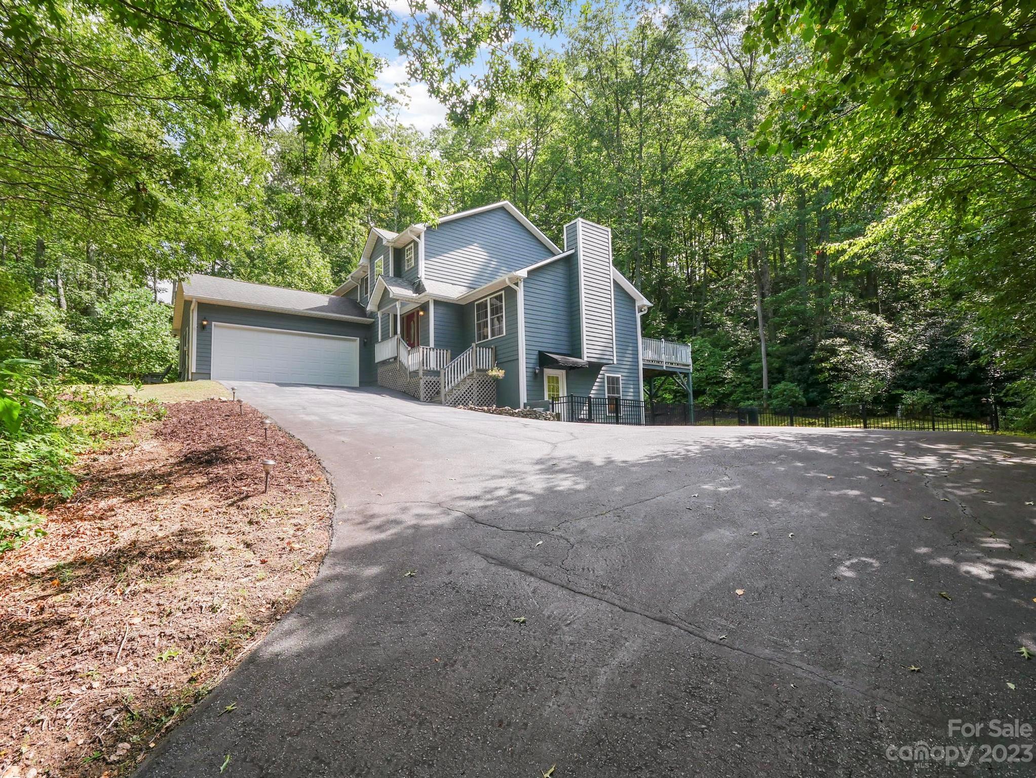 25 Falcon Crest Drive Fairview, NC 28730 - Photo 37 of 41 a front view of a house with a yard and garage