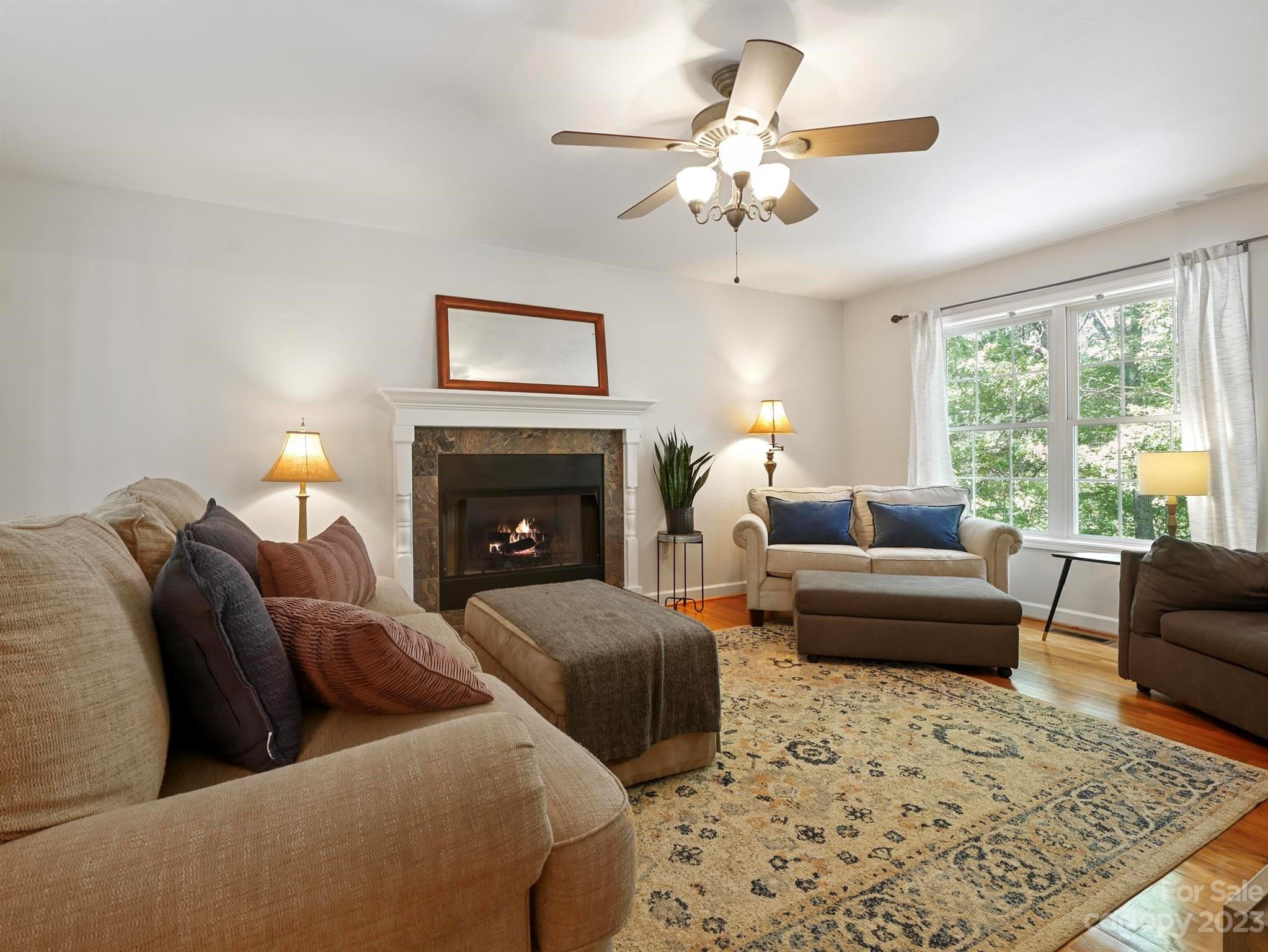 25 Falcon Crest Drive Fairview, NC 28730 - Photo 7 of 41 a living room with furniture and a fireplace