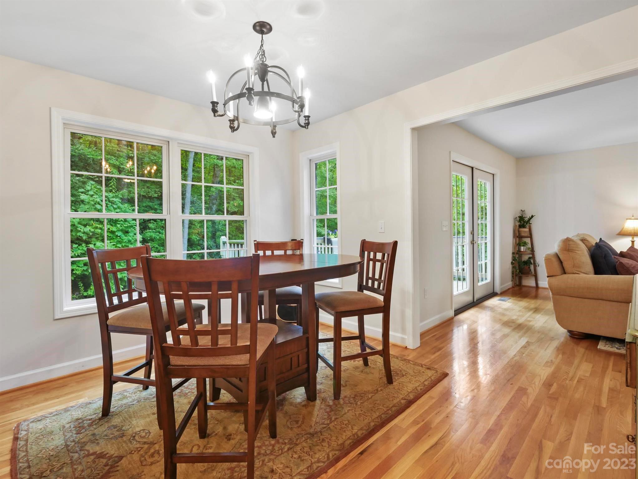 25 Falcon Crest Drive Fairview, NC 28730 - Photo 8 of 41 a view of a dining room with furniture wooden floor and chandelier