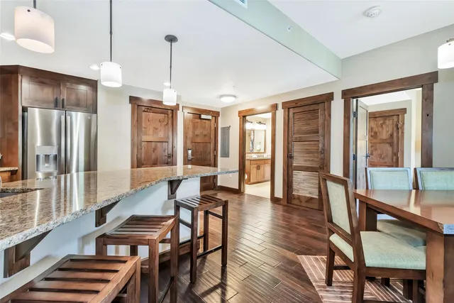 a dining room with furniture a chandelier and wooden floor
