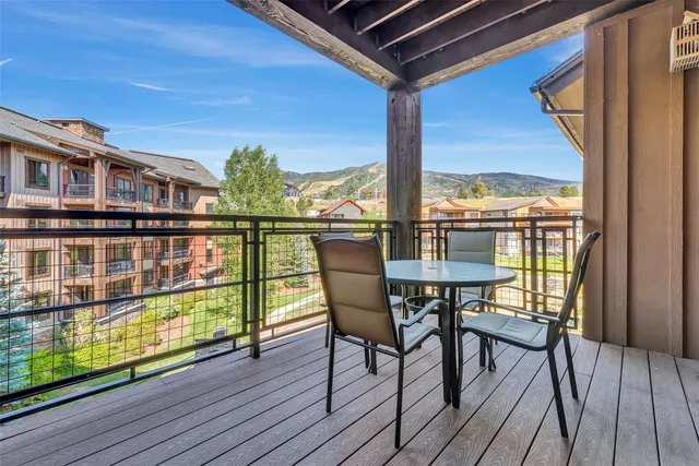 a view of a chairs and table in the balcony