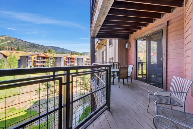 a kitchen view with a large window and cabinets