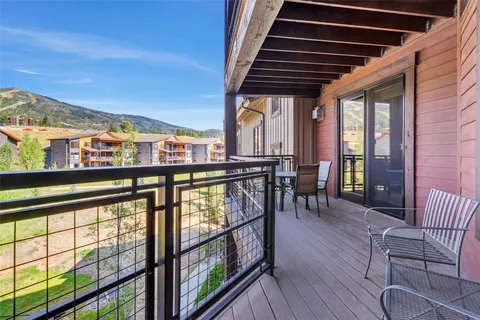 a view of a chairs and table in the balcony