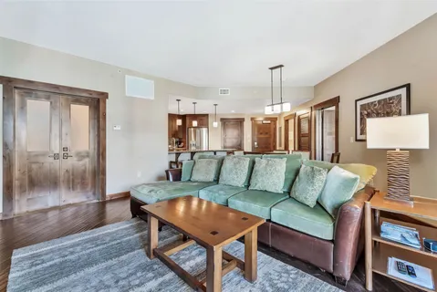 a living room with furniture and a chandelier