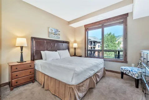 a bed sitting in a bedroom next to a window