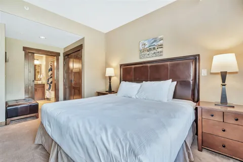 a bedroom with a bed and a night stand