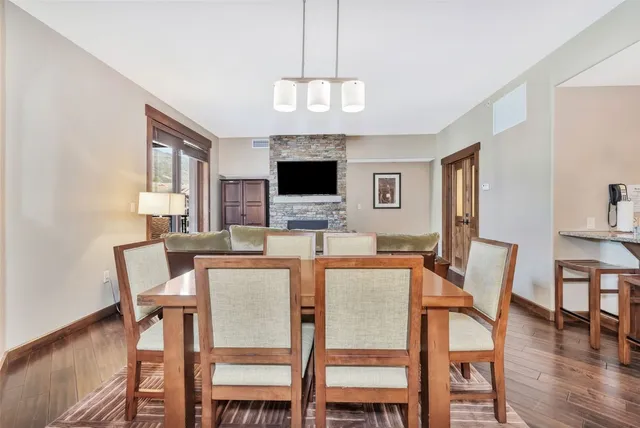 a dining room with furniture and a view of kitchen