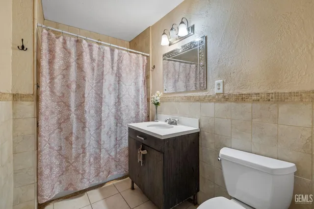 a kitchen with stainless steel appliances granite countertop a refrigerator a stove and a sink