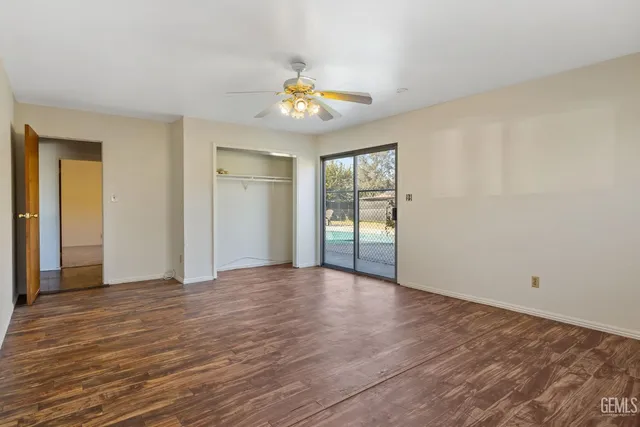 a kitchen with white cabinets and window