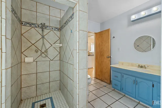 a view of a dining room and livingroom with furniture wooden floor a chandelier