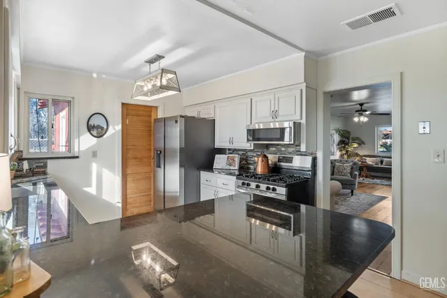 a view of a room with furniture and wooden floor