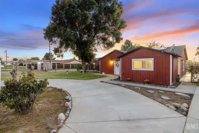 a front view of house with yard and trees