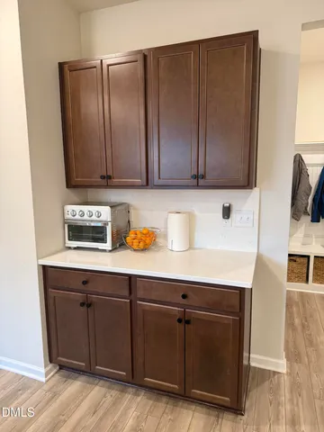 a room with a sink cabinets and wooden floor