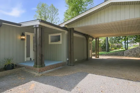 a backyard of a house with table and chairs