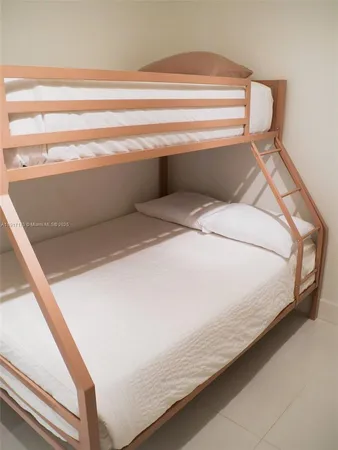 a bed sitting in a bedroom next to a cabinet