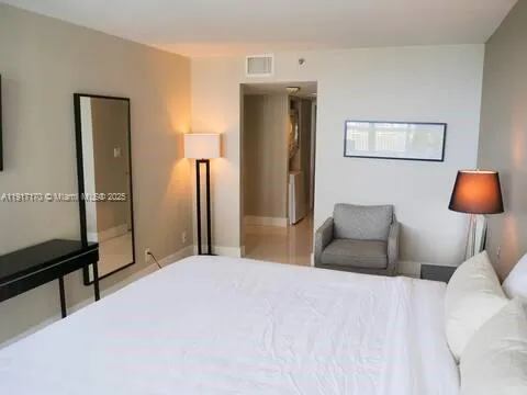 a bedroom with a bed and a lamp