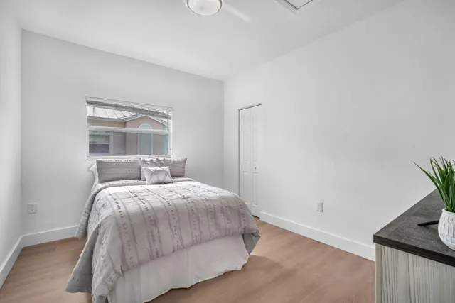 a bedroom with a bed and a window