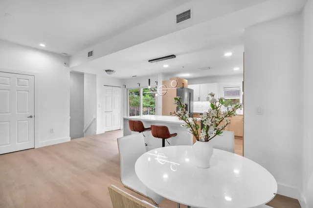 a large white vase with white and yellow flowers