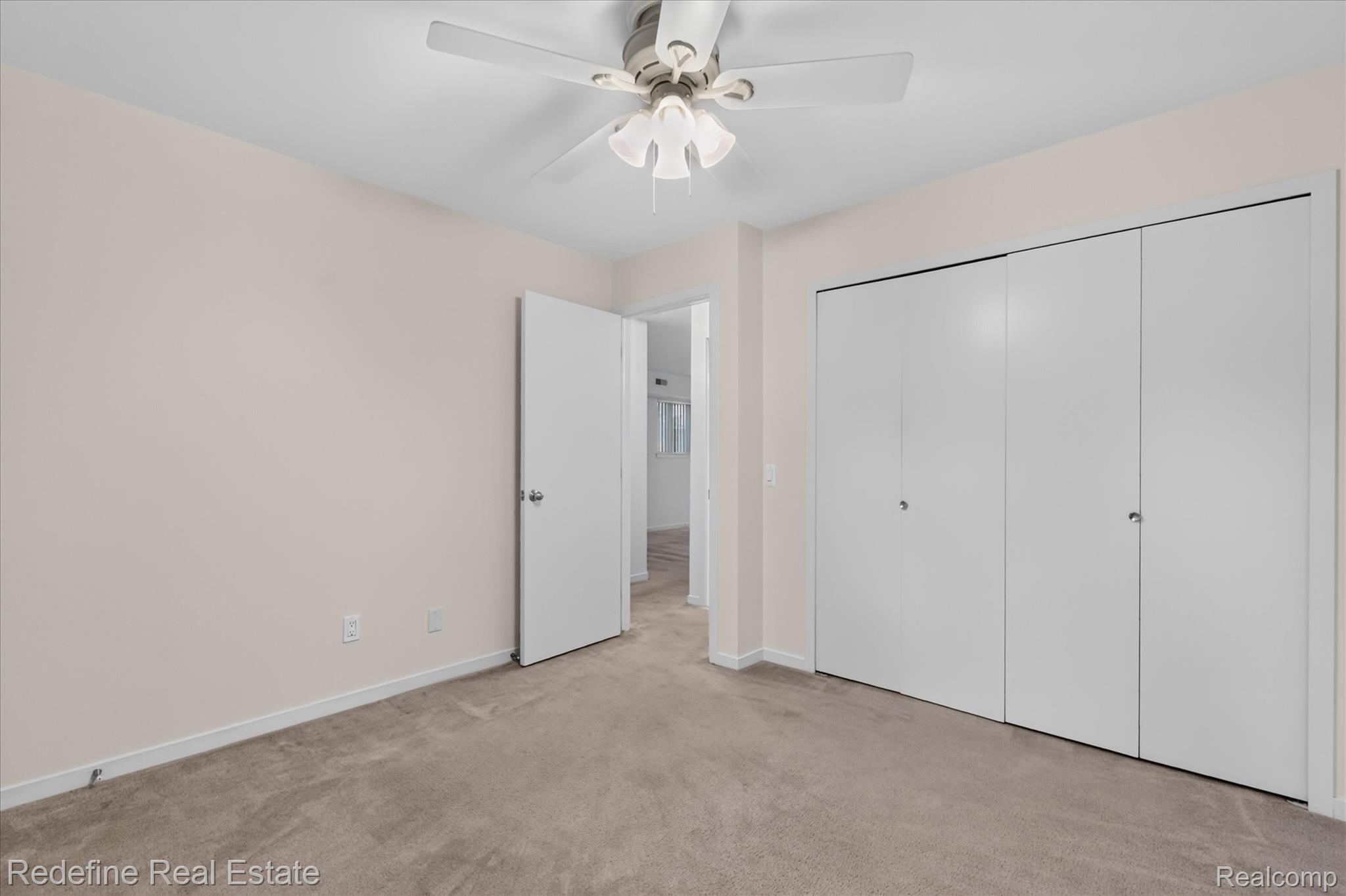 27971 Rollcrest Road, Unit 9 Farmington, MI 48334 - Photo 16 of 25 Neutral-toned wall paint, ceiling fan with light fixture, light-colored carpet flooring, and bi-fold closet doors