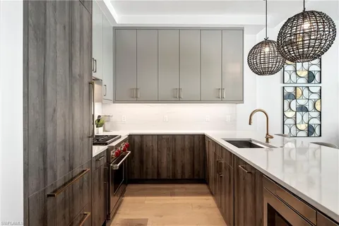 a kitchen with a sink cabinets and appliances