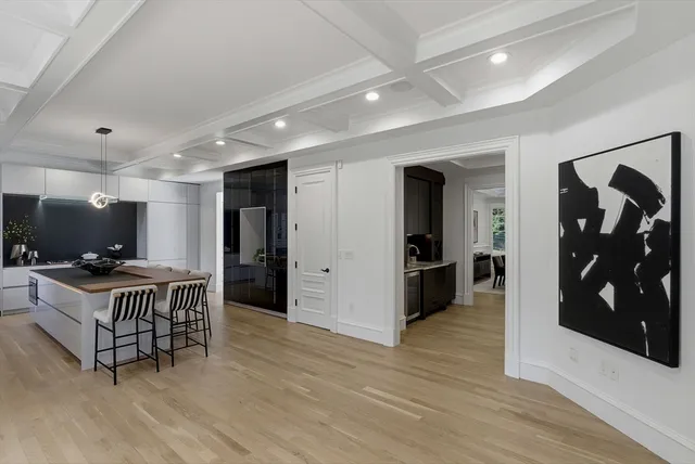 a kitchen with a table chairs refrigerator and microwave