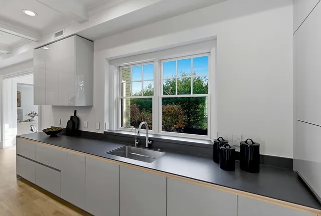 a kitchen with a table chairs stove and cabinets