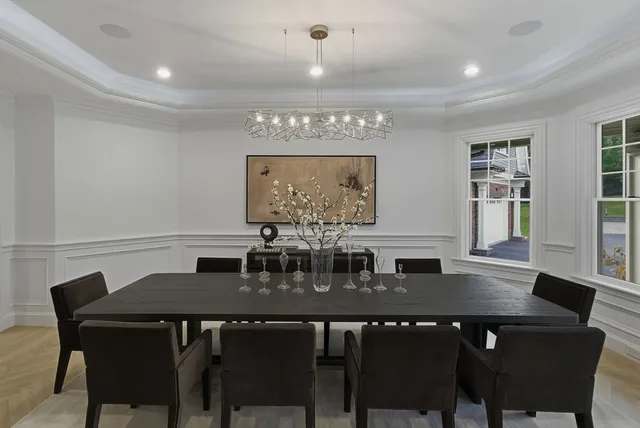 a view of a hallway with a couch and chandelier