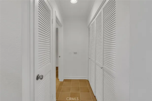 a view of a room with wooden floor and a window