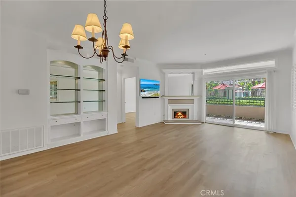 a view of a kitchen with wooden floor and a fireplace