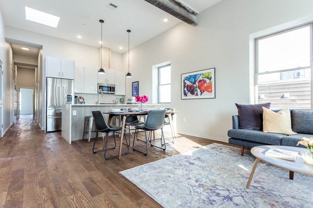178 Elm Street, Unit 5 Cambridge, MA 02139 - Photo 1 of 14 a living room with stainless steel appliances kitchen island granite countertop furniture wooden floor and a large window