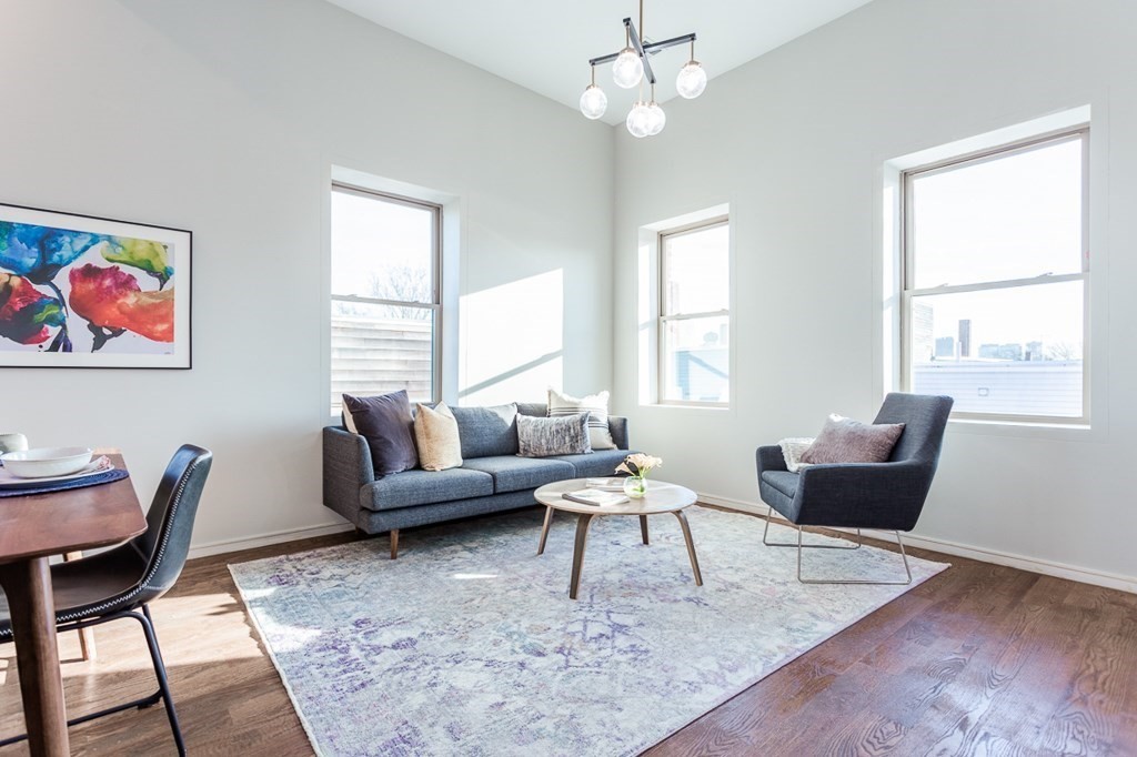 178 Elm Street, Unit 5 Cambridge, MA 02139 - Photo 2 of 14 a living room with furniture a wooden floor and a large window