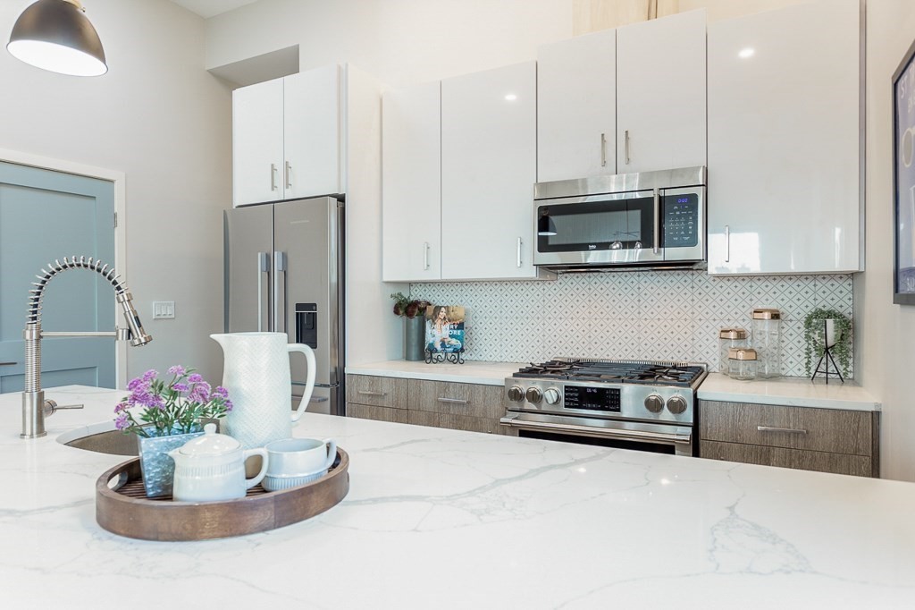 178 Elm Street, Unit 5 Cambridge, MA 02139 - Photo 5 of 14 a kitchen with a sink a stove and cabinets