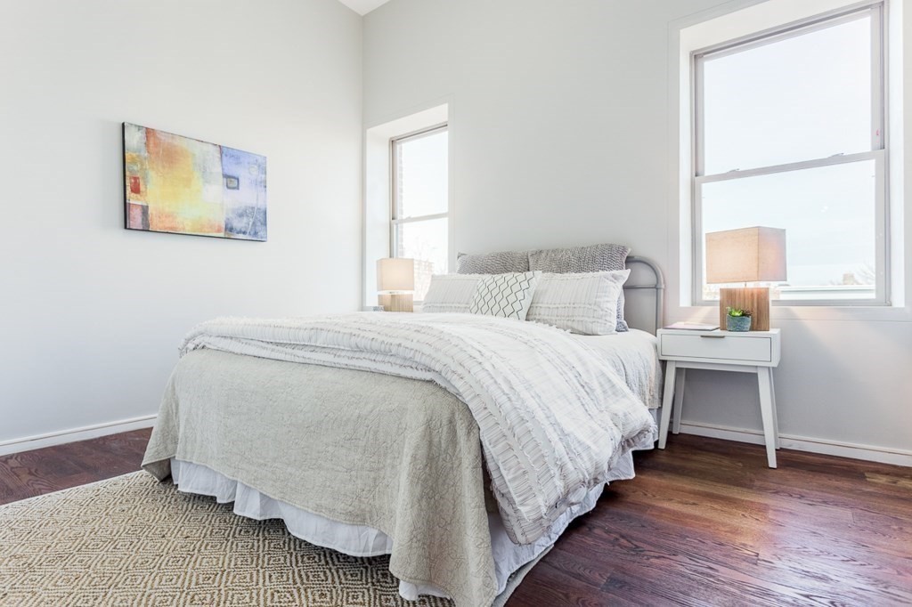 178 Elm Street, Unit 5 Cambridge, MA 02139 - Photo 9 of 14 a bedroom with a bed and wooden floor