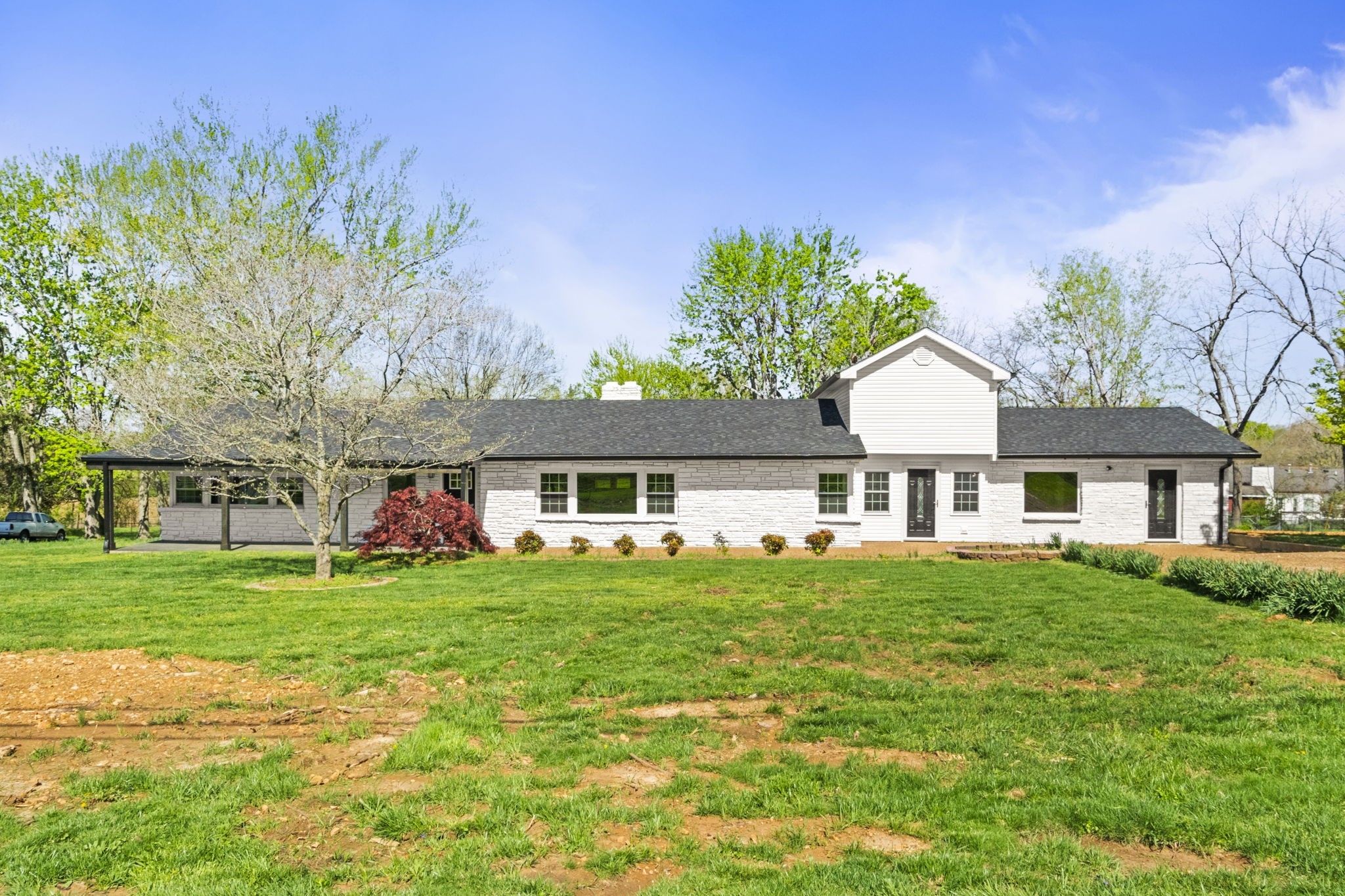 a front view of a house with a garden