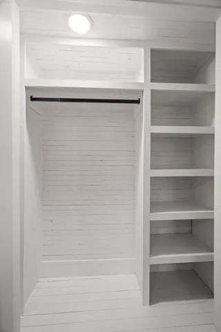 a kitchen with granite countertop white cabinets and window