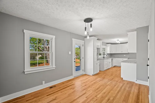 a kitchen with stainless steel appliances granite countertop a sink stove and cabinets