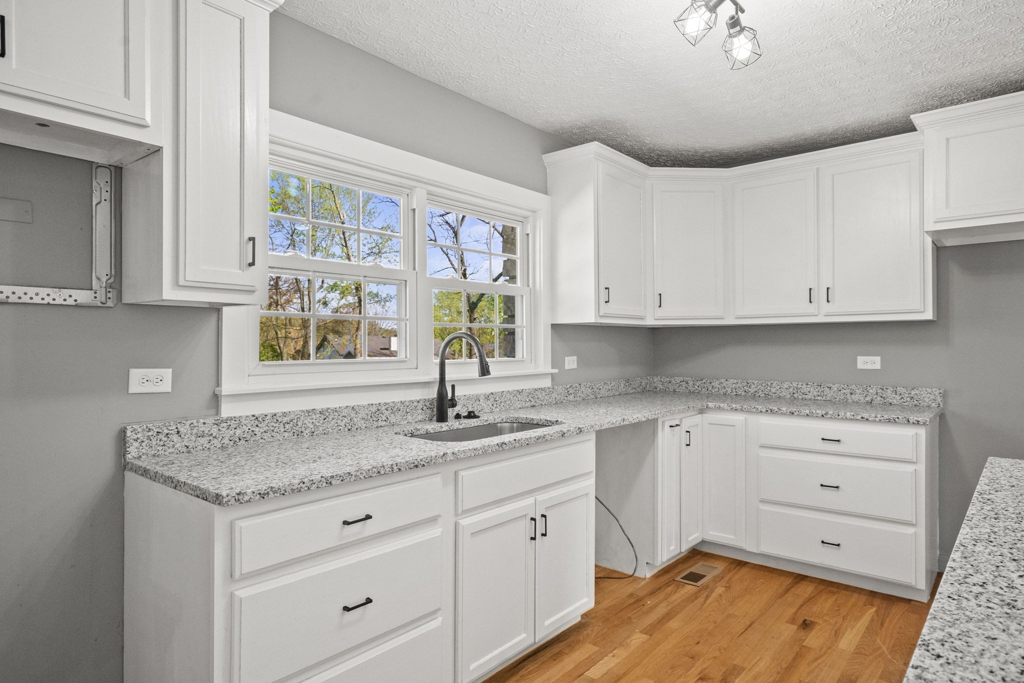 1503 5th Avenue West Springfield, TN 37172 - Photo 32 of 57 a kitchen with granite countertop white cabinets and window