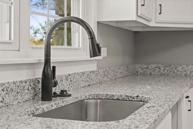 a bathroom with a toilet a sink and a large mirror