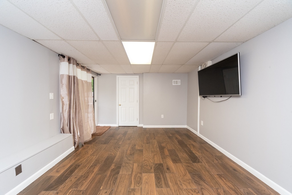 13 Westgate Road Framingham, MA 01701 - Photo 15 of 24 wooden floor in an empty room with a window
