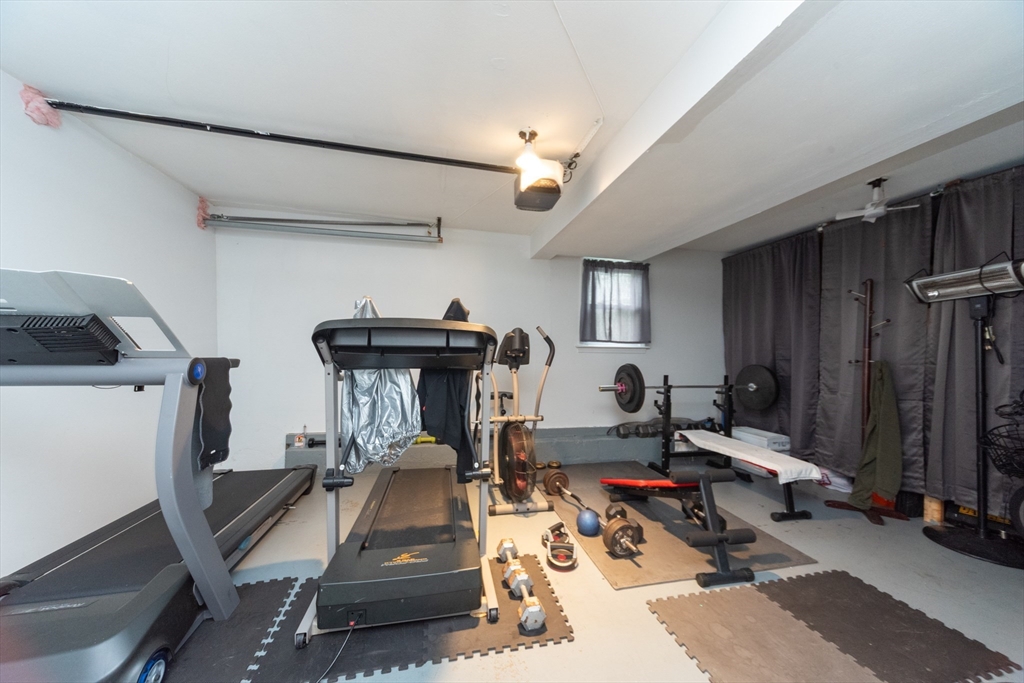 13 Westgate Road Framingham, MA 01701 - Photo 16 of 24 a room with gym equipment and a window
