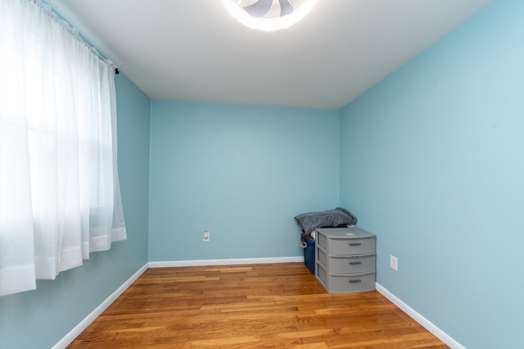 13 Westgate Road Framingham, MA 01701 - Photo 10 of 24 a room with wooden floor and chair