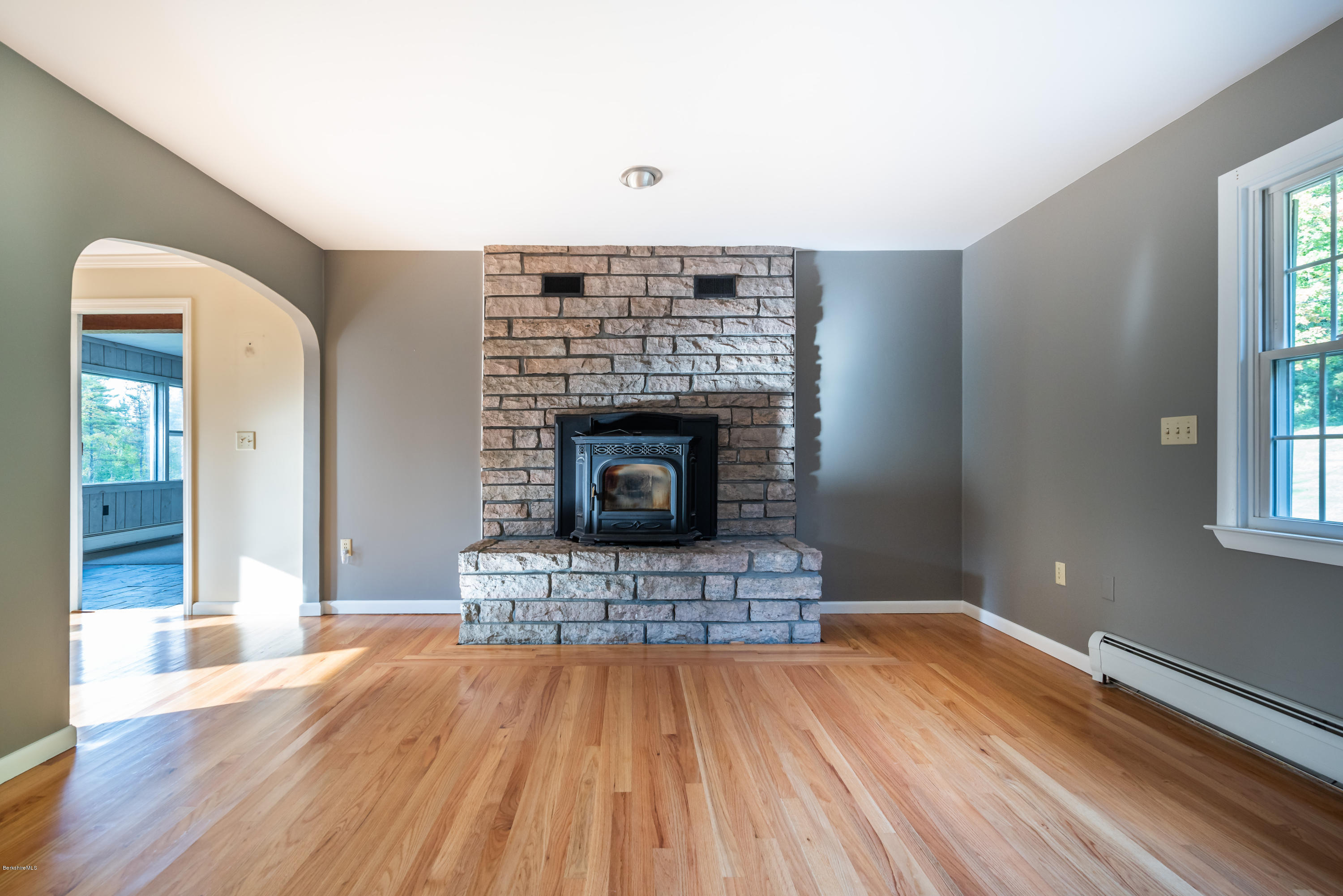 552 E Road Richmond, MA 01254 - Photo 13 of 42 a living room with a fireplace and wooden floor