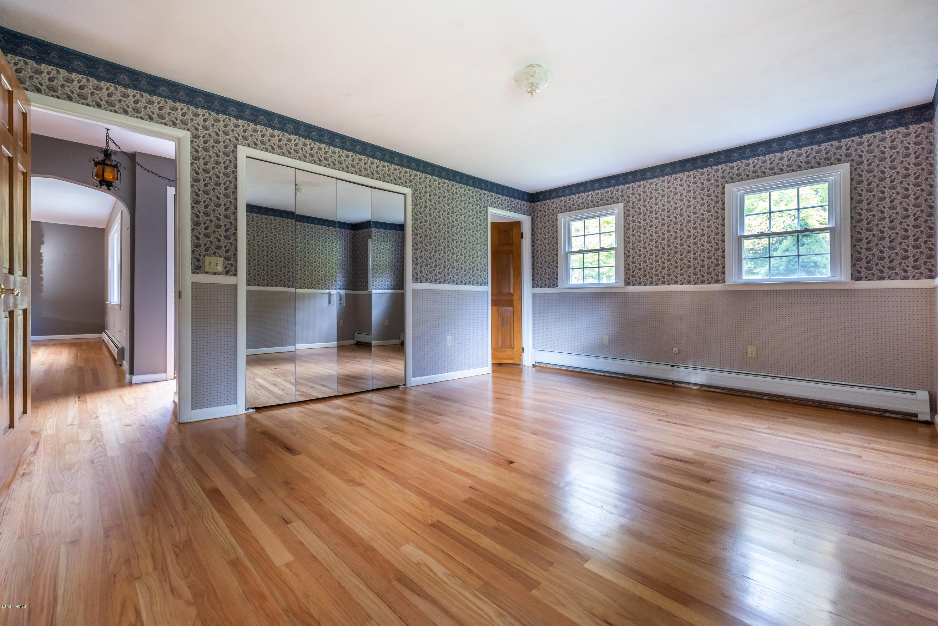 552 E Road Richmond, MA 01254 - Photo 18 of 42 an empty room with wooden floor and windows