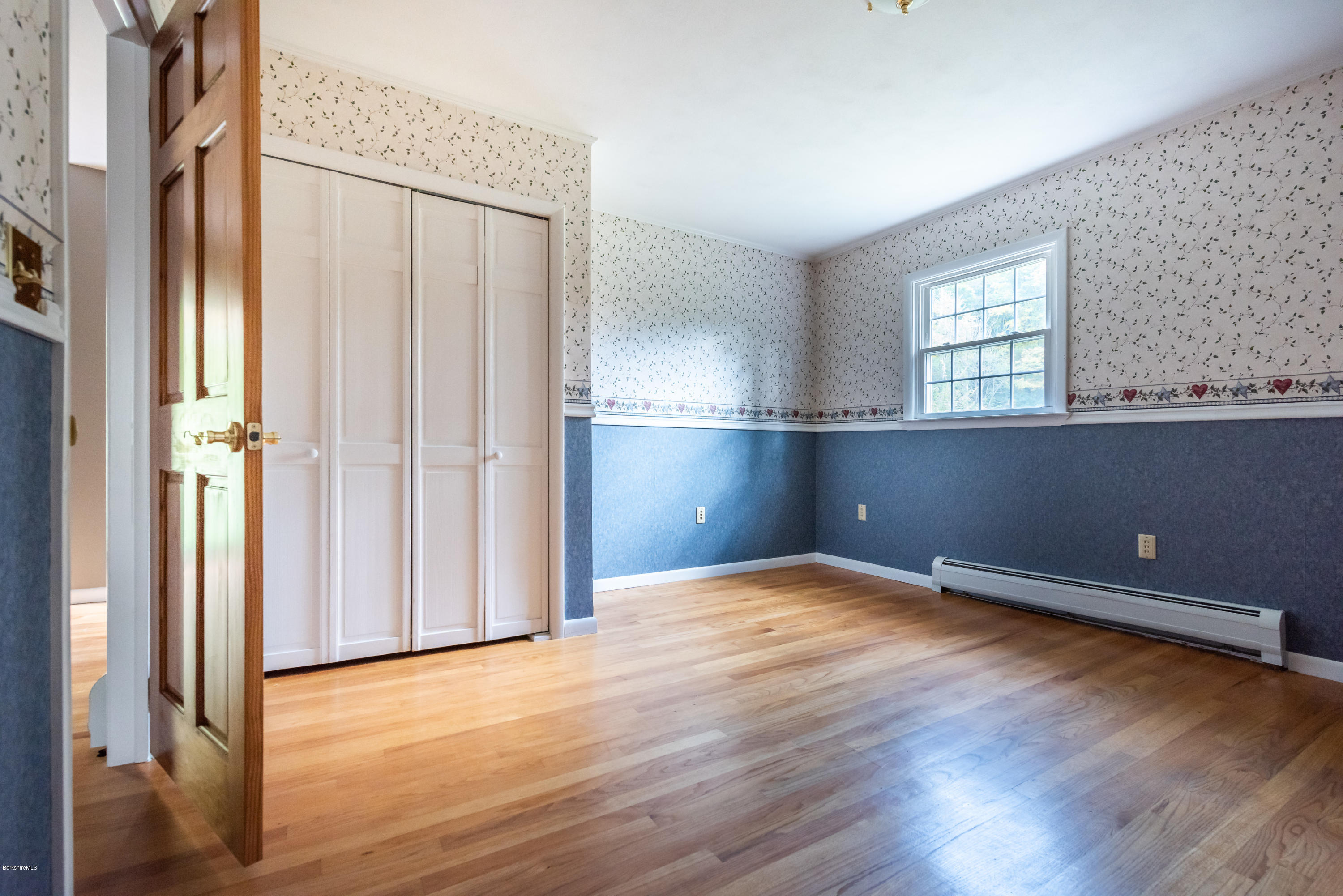552 E Road Richmond, MA 01254 - Photo 19 of 42 an empty room with wooden floor and windows
