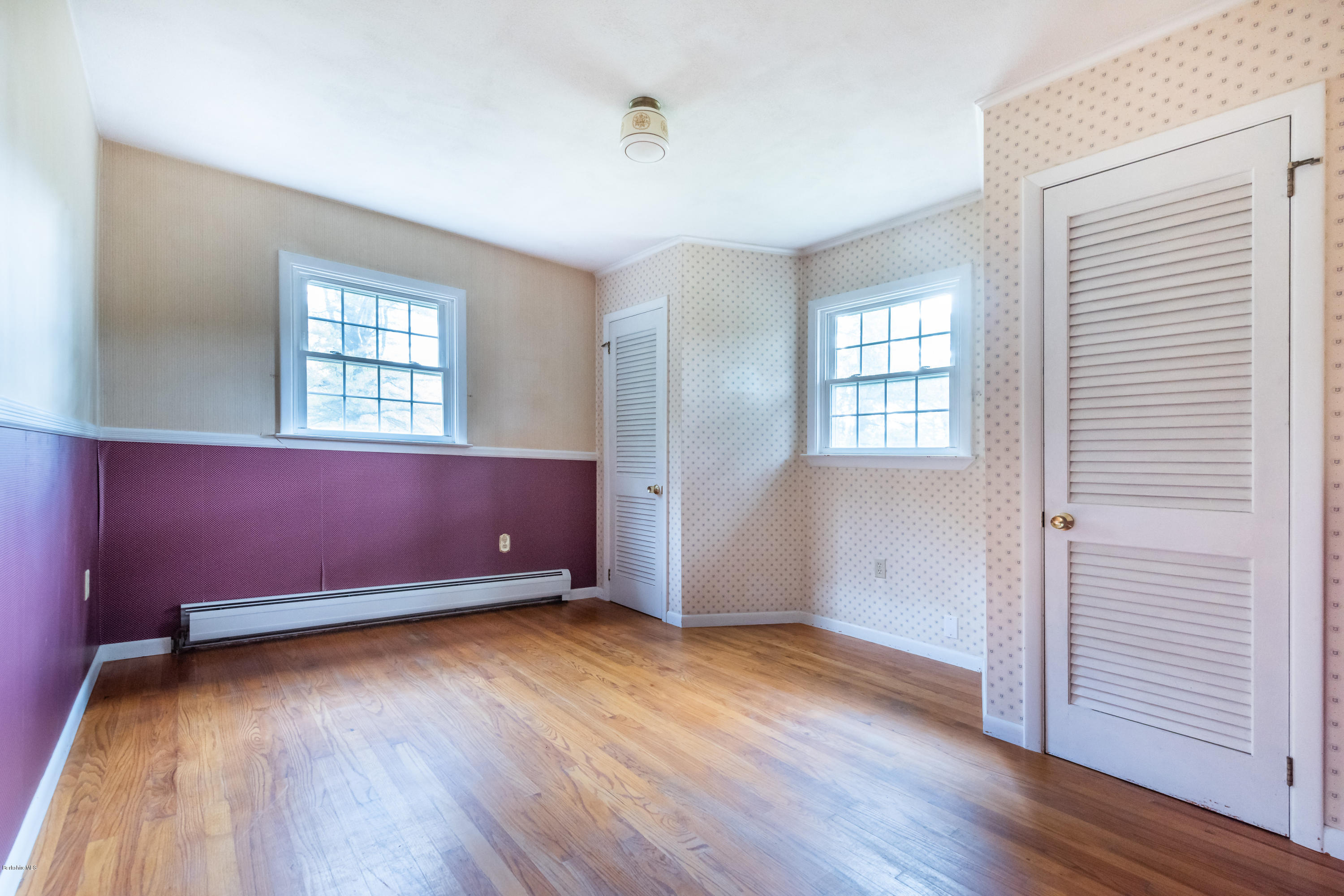 552 E Road Richmond, MA 01254 - Photo 20 of 42 an empty room with wooden floor and windows