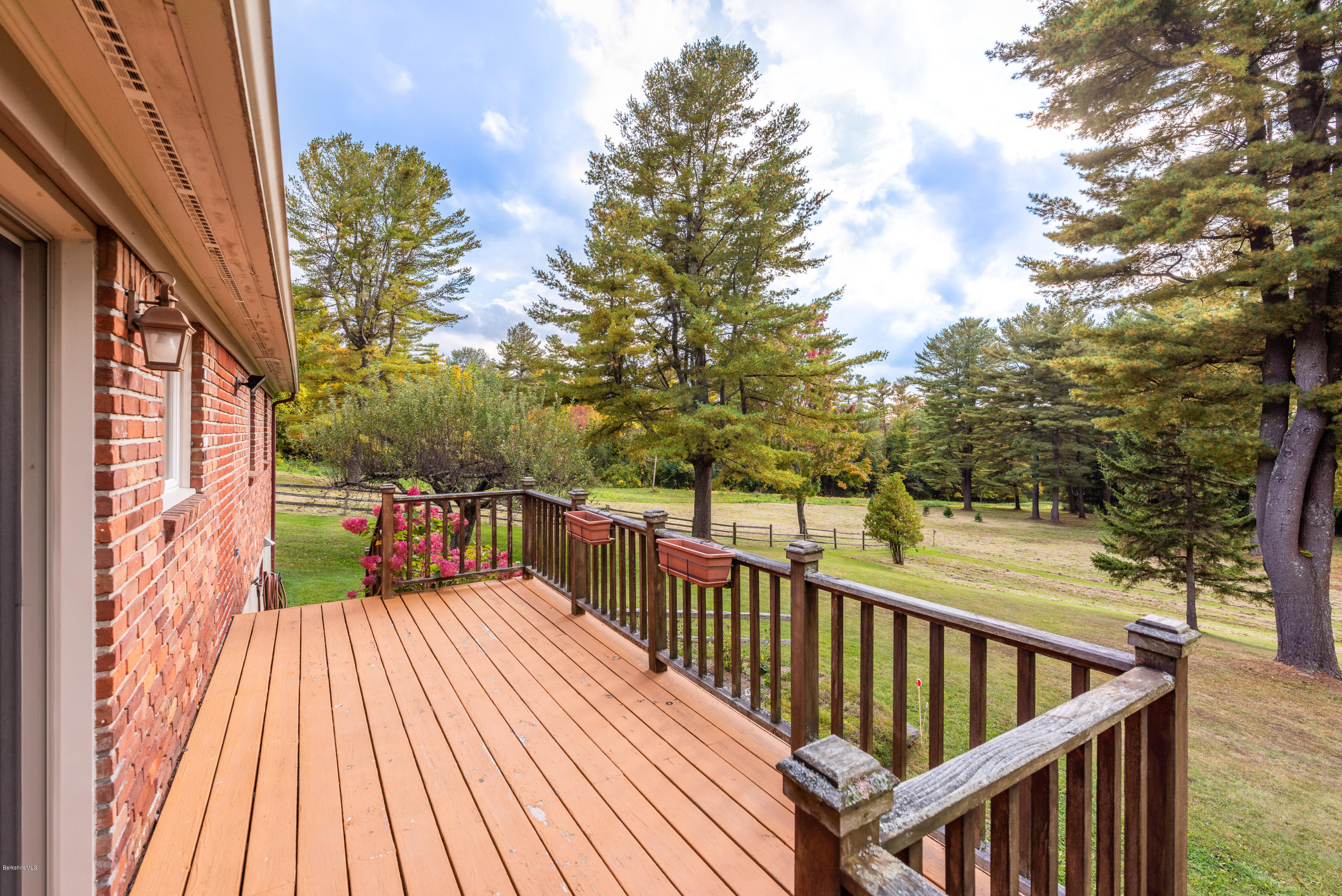 552 E Road Richmond, MA 01254 - Photo 24 of 42 a balcony with wooden floor and trees