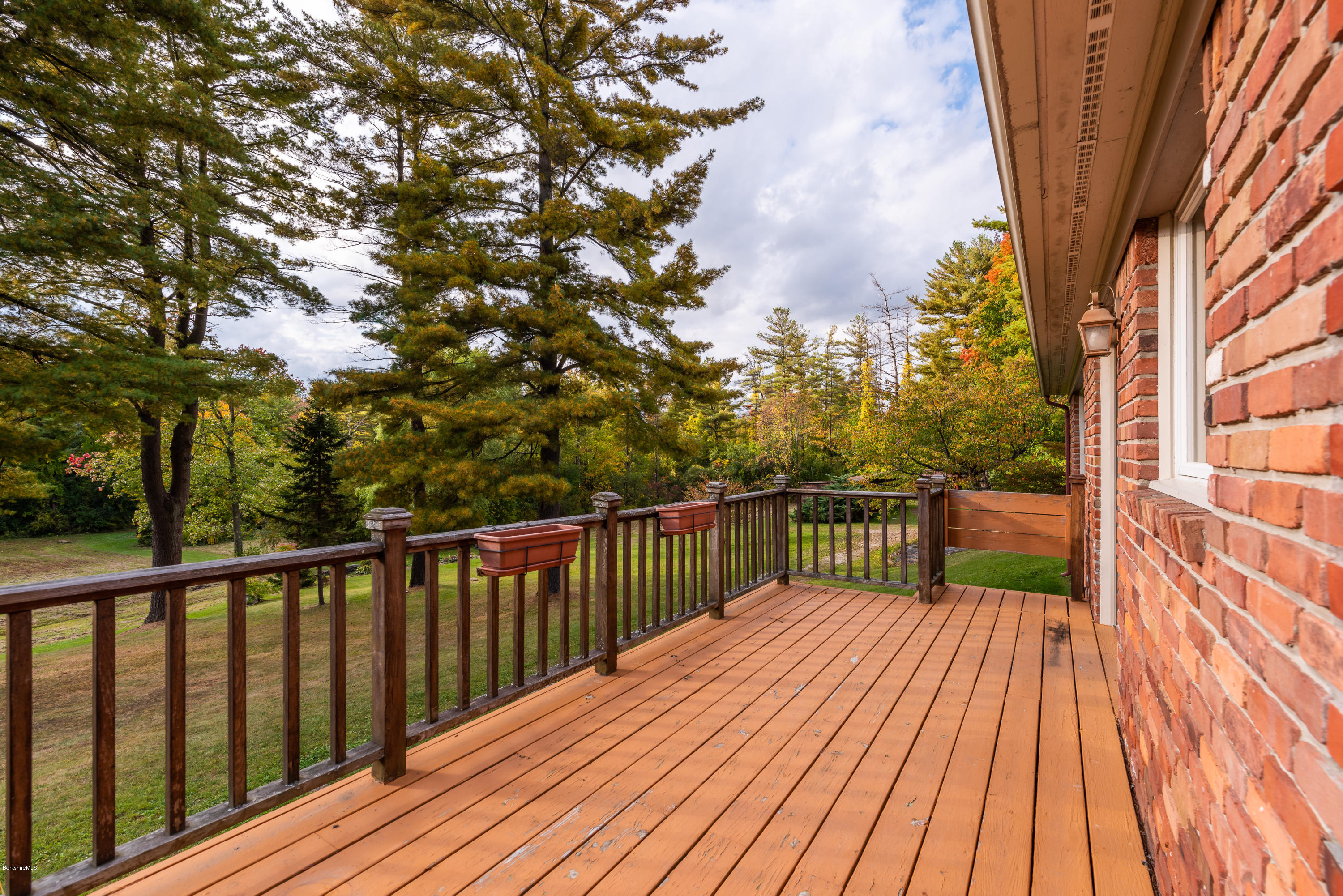 552 E Road Richmond, MA 01254 - Photo 25 of 42 a balcony with wooden floor and trees