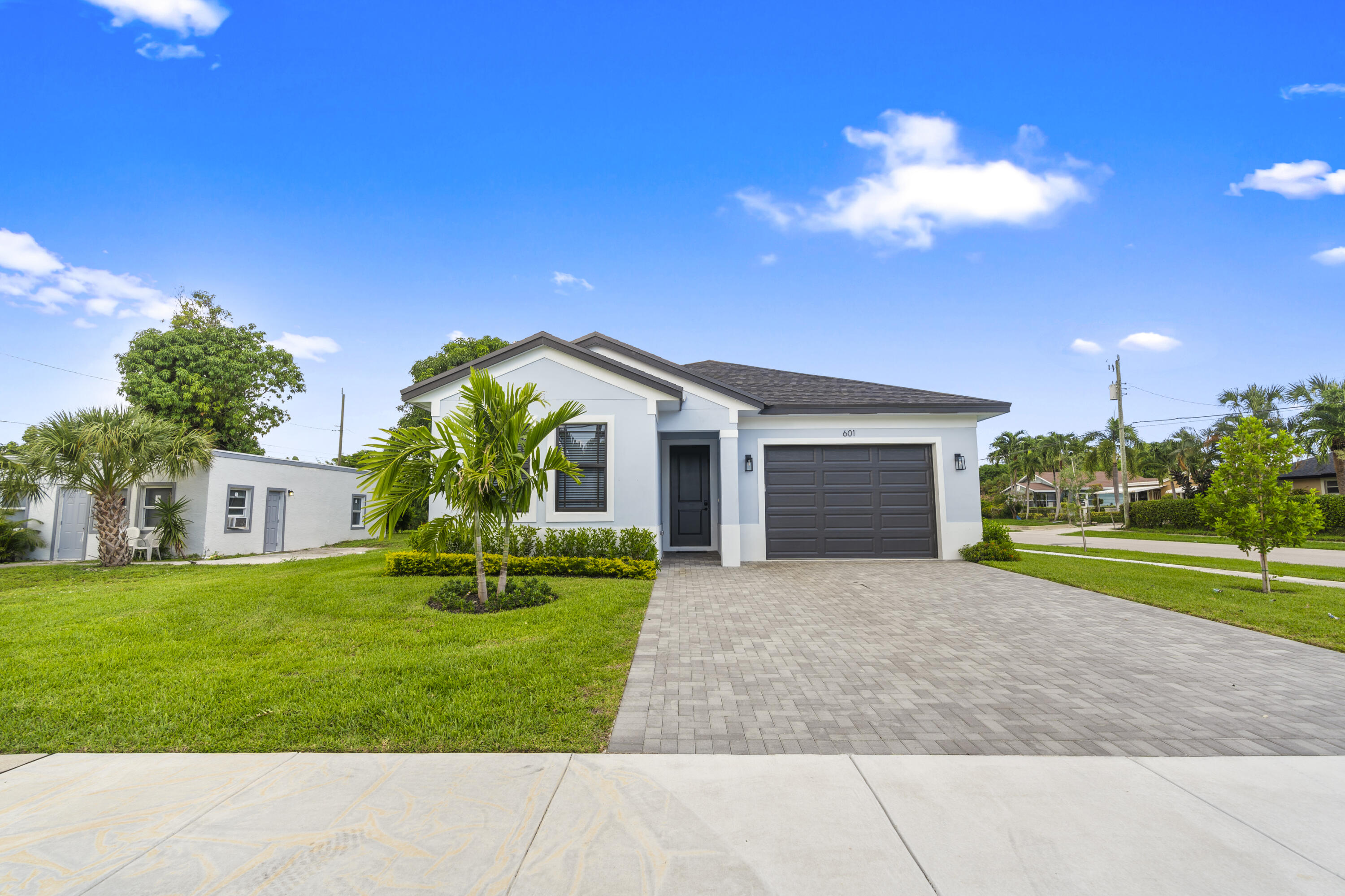 601 Southwest 3rd Street Delray Beach, FL 33444 - Photo 63 of 75 a front view of a house with a yard and garage