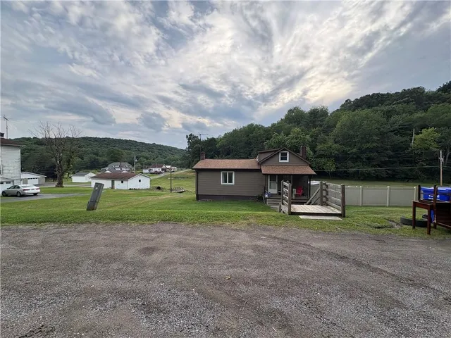 a view of house with outdoor space and porch